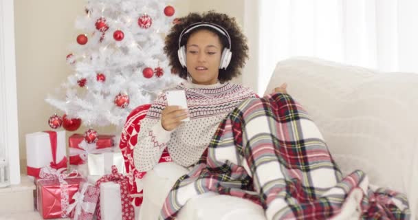 Glückliche Frau, die am Weihnachtstag Musik hört — Stockvideo