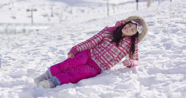 Jeune femme en costume de neige rose avec lunettes de ski — Video