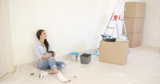 Moe jonge vrouw ontspannen tijdens renovaties — Stockvideo