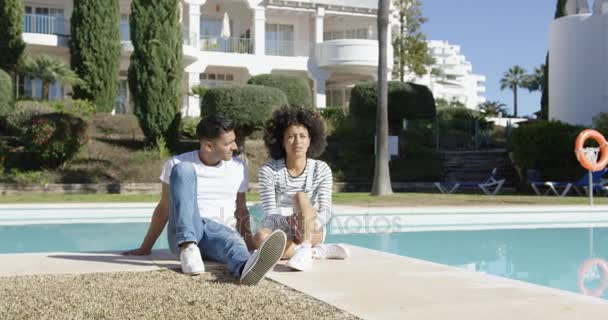 Jovem casal relaxante ao lado de uma piscina urbana — Vídeo de Stock