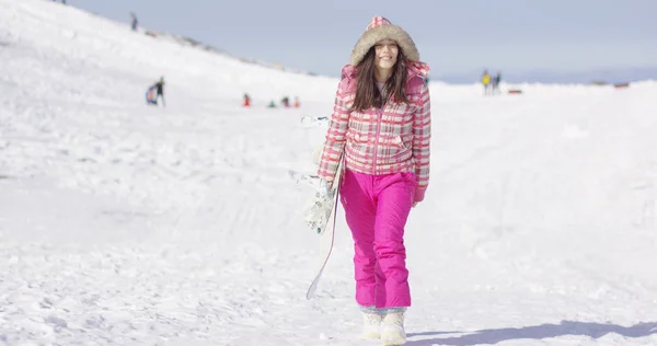 Jonge vrouw lopen met snowboard — Stockfoto