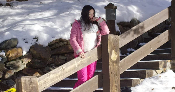 Adorable asian girl standing on wooden stairs — Stock Photo, Image