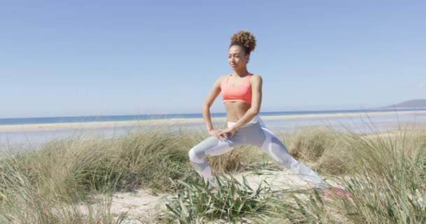 Vrouw warmin omhoog op het strand — Stockvideo