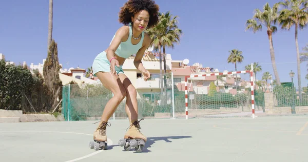 Young pretty woman riding in roller skates — Stock Photo, Image