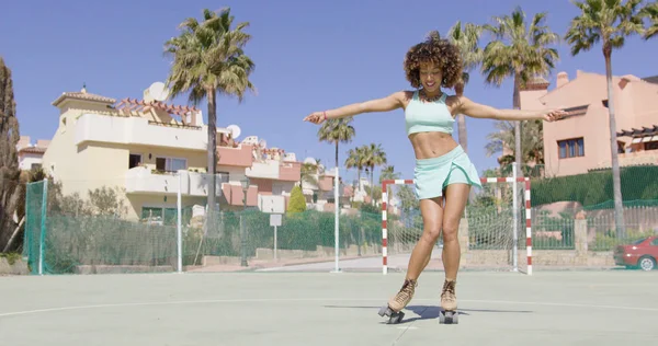 Young pretty woman dancing in roller skates — Stock Photo, Image