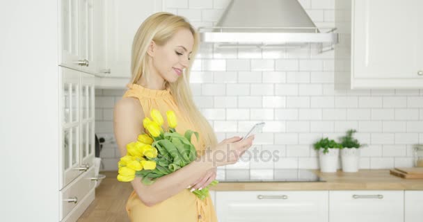 Lovely female with flowers and phone — Stock Video