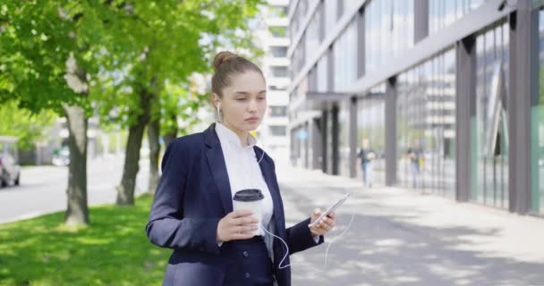 Pretty formal woman with coffee and smartphone — Stock Video