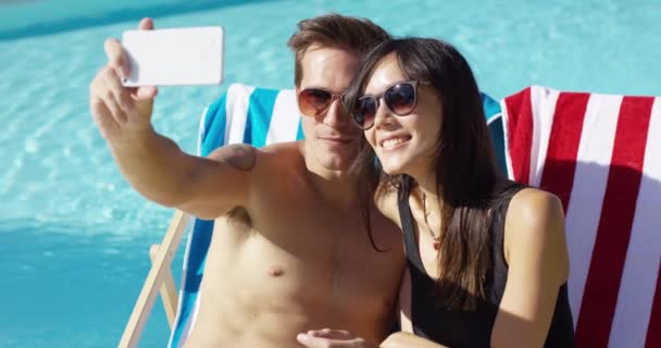 Smiling young couple taking a vacation selfie — Stock Video