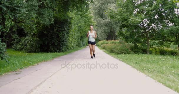 Cheerful woman running in park — Stock Video