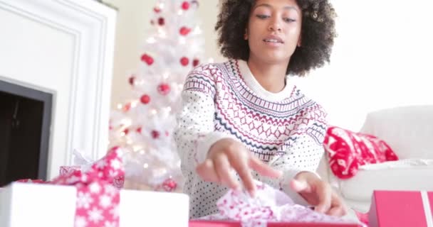 Jonge vrouw opent haar Kerstcadeaus — Stockvideo