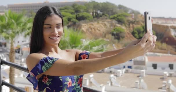 Confident model taking selfie on resort — Stock Video