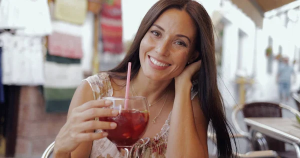 Usmívající se žena pózuje s nápojem v kavárně — Stock fotografie