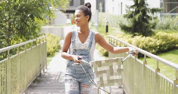 Young girl walking with bicycle — Stock Photo, Image