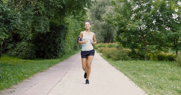 Fröhliche Frau läuft in Park — Stockfoto