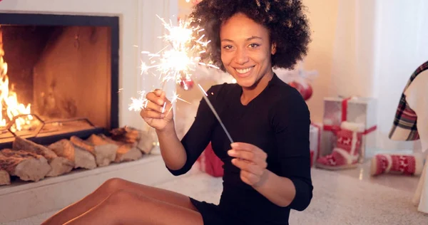 Mujer sonriente celebrando Navidad con bengalas — Foto de Stock