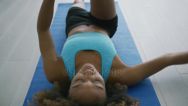 Sportive model flexing body on mat — Stock Video