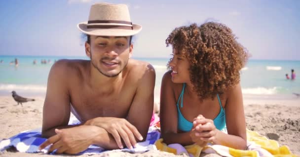 Пара лежить один біля одного на пляжі — стокове відео