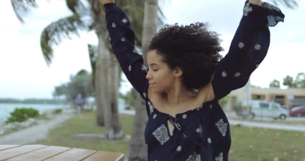 Dreaming content girl enjoying wind on shore — Stock Video