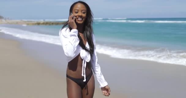 Mujer sonriendo y hablando por teléfono en la playa — Vídeos de Stock