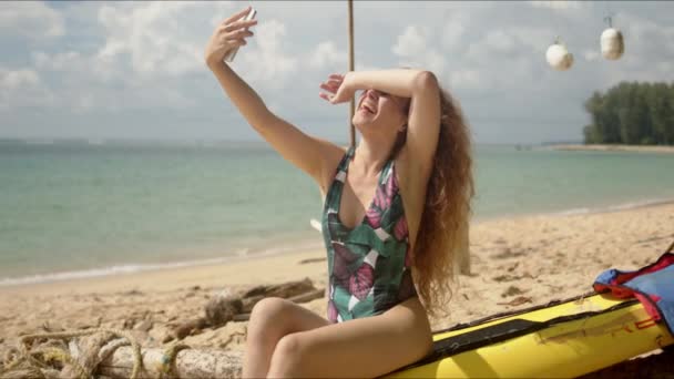 Donna attraente che prende selfie sulla spiaggia — Video Stock