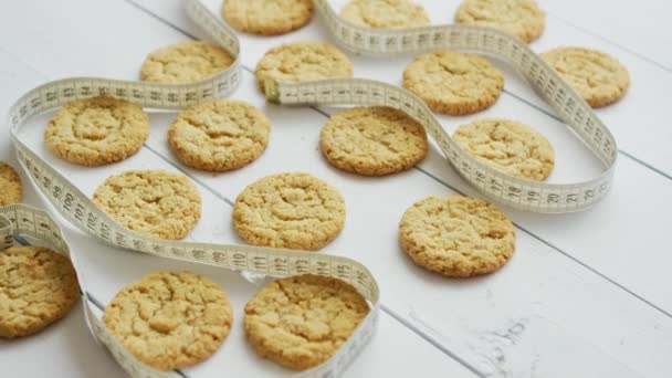 Healthy oatmeal cookies on white wood background, side view. — Stock Video