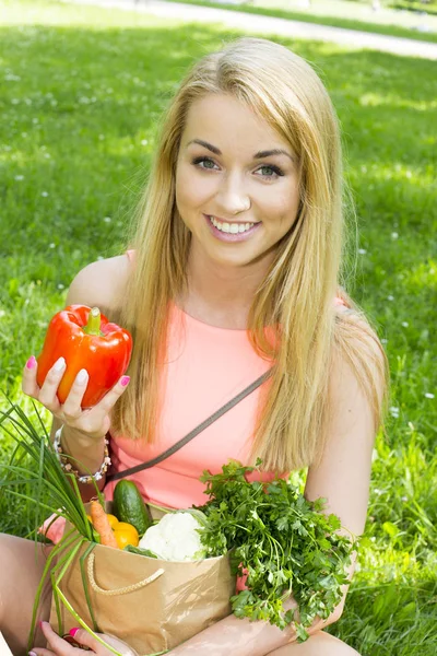 Young woman with a shopping bag. vegetables Royalty Free Stock Images