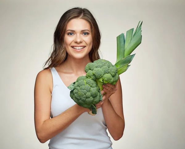 Femme souriante tenant brocoli avec poireau . — Photo