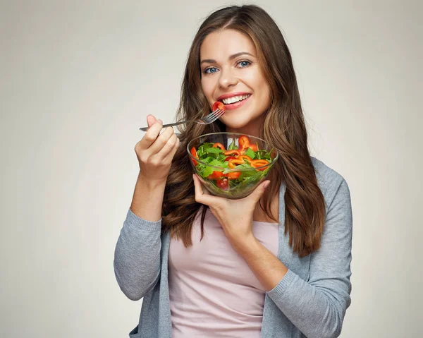 Happy woman eating salad from glass bowl with fork. — Stock Photo, Image