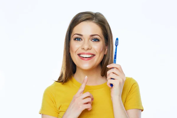 Smiling woman holding toothy brush. Isolated studio portrait. — Stock Photo, Image