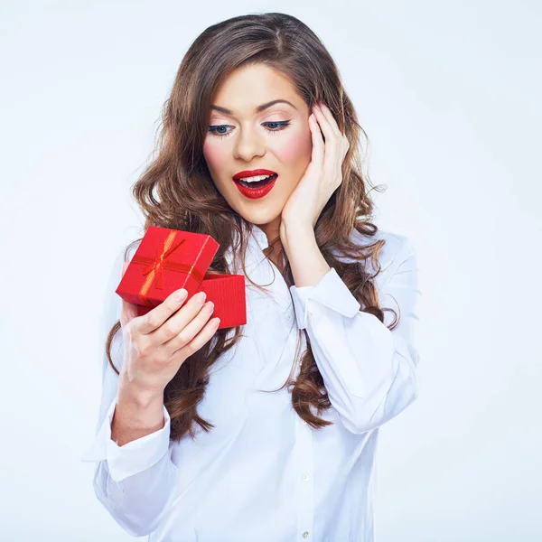 Surprising woman holding little red gift. Curly long hair. — Stock Photo, Image