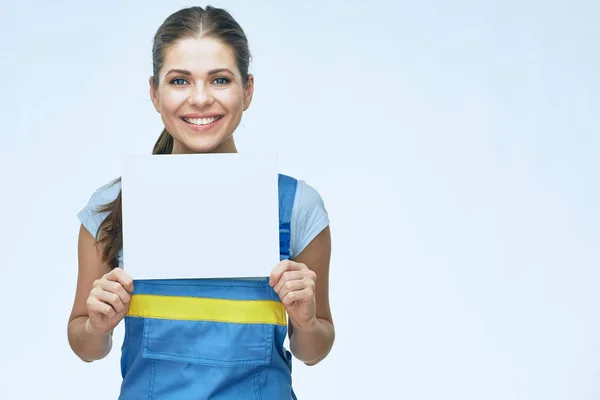 Woman in coverall holding white banner — Stock Photo, Image