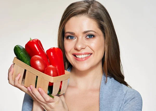 Woman holding basket with vegetables — Stock Photo, Image