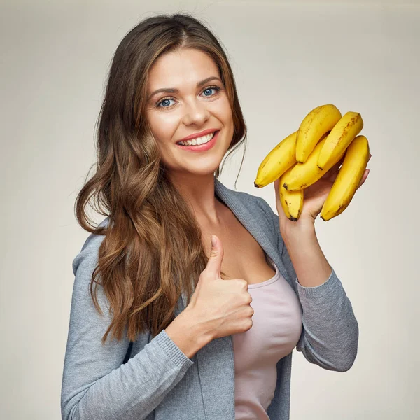 Usmívající se žena drží banán Ukázat palec. — Stock fotografie
