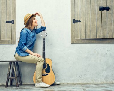 Akustik gitarda eğilerek kadın 