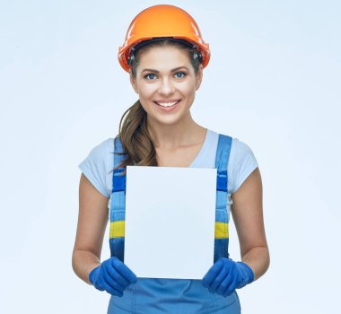 Beyaz afiş tutarak koruyucu kask içinde gülümseyen kadın Oluşturucu 