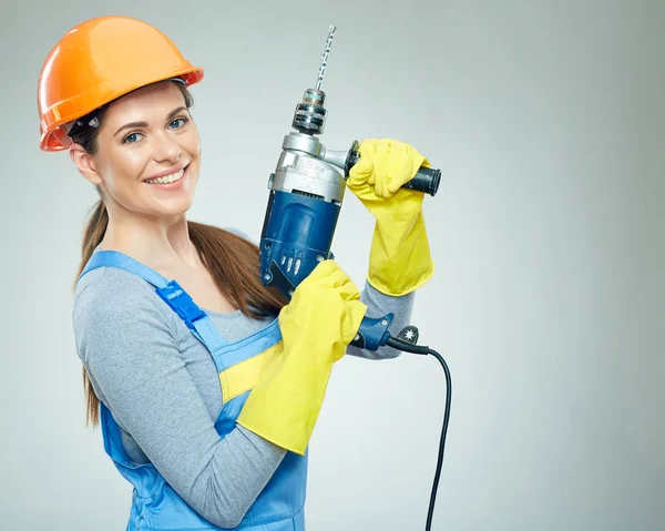 woman builder holding drill tool