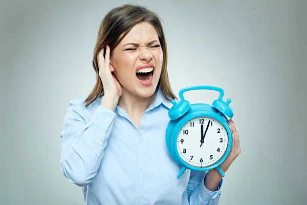 Scared businesswoman holding alarm clock — Stock Photo, Image