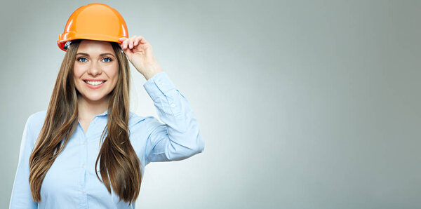 Smiling Business woman wearing builder helmet. 
