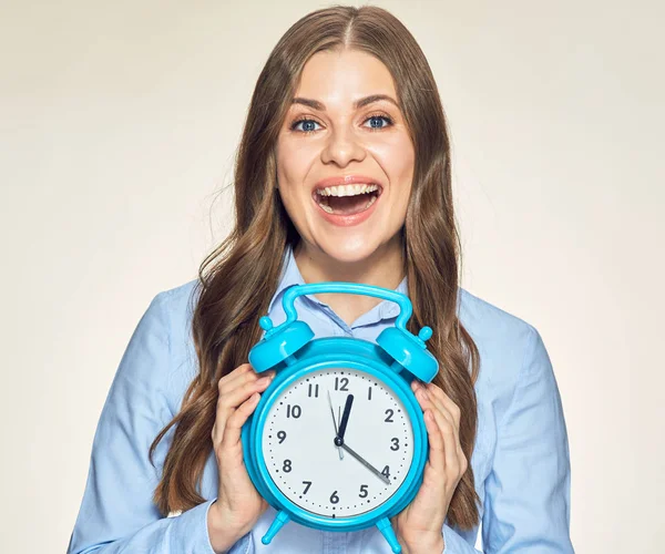 Woman holding alarm clock in hands — Stock Photo, Image