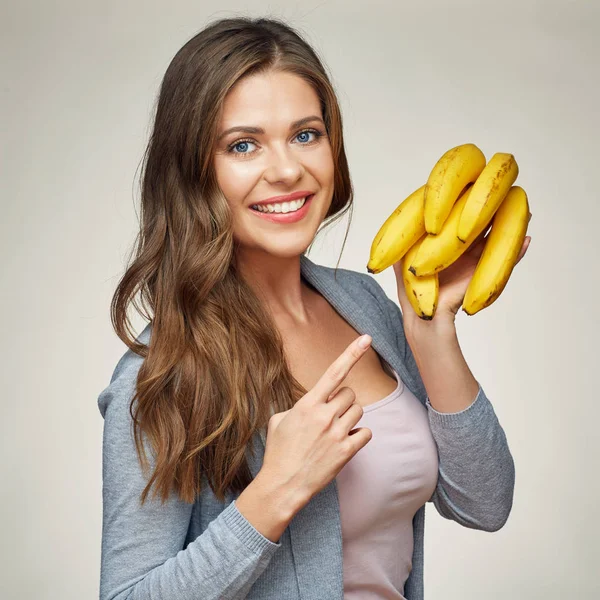 Smiling woman holding yellow bananas