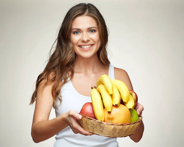 Mulher sorrindo segurando cesta de palha com comida saudável . — Fotografia de Stock