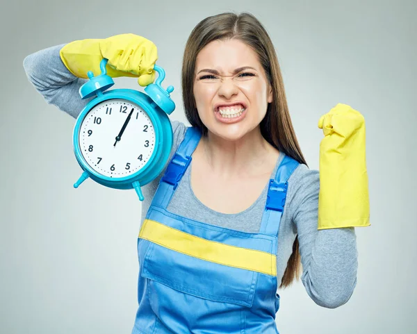 Shocking woman builder holding alarm clock. — Stock Photo, Image