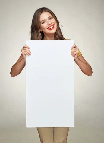 Woman smiling with teeth holding advertising white sign board — Stock Photo, Image