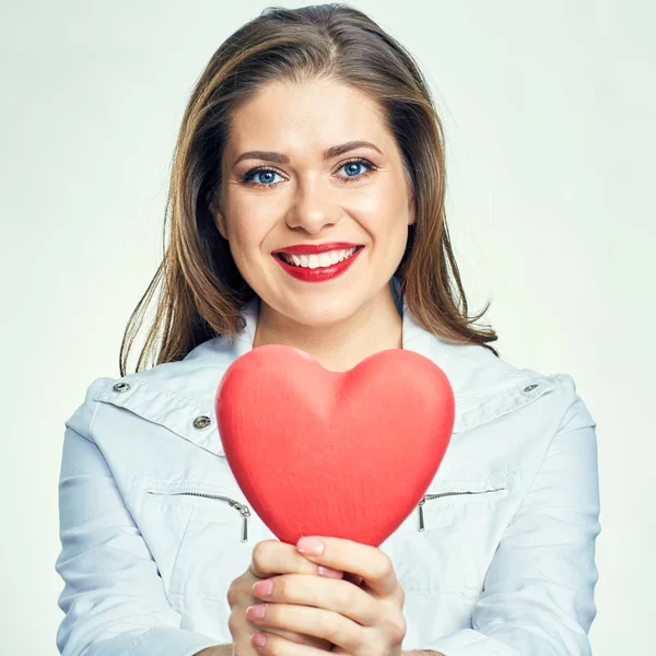 Smiling woman holding red heart — Stock Photo, Image