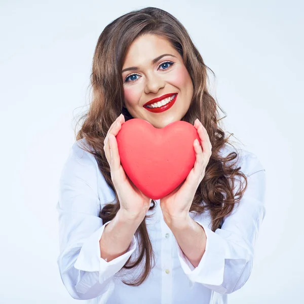 Woman holding red heart on blue — Stock Photo, Image