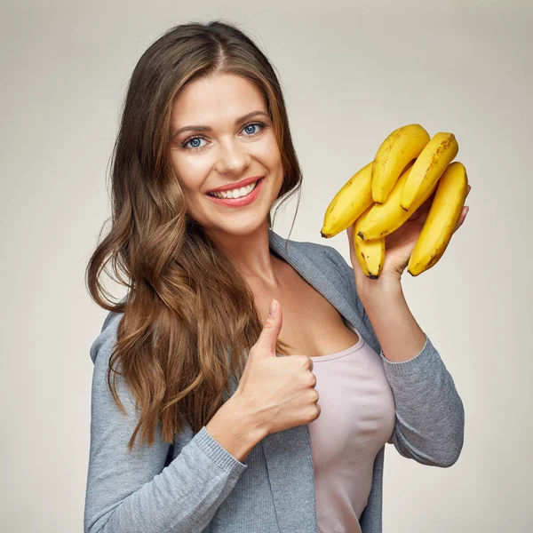 Smiling woman holding yellow bananas