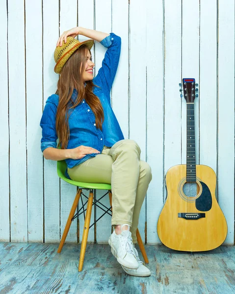 Smiling young woman with long hair sitting on chai — Stock Photo, Image