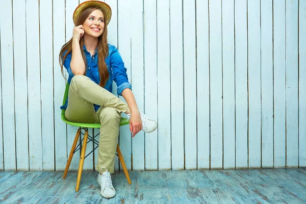 Beautiful young hipster girl sitting on chair. — Stock Photo, Image