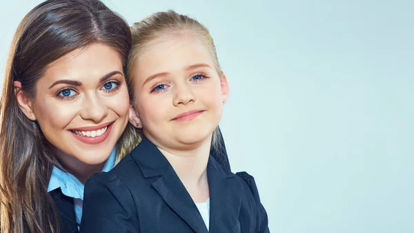 Sonriente madre con hija en trajes de negocios . — Foto de Stock