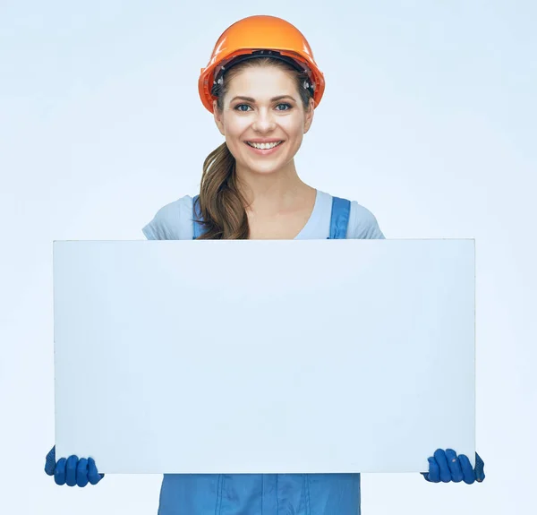 Smiling woman builder holding white baneer. — Stock Photo, Image